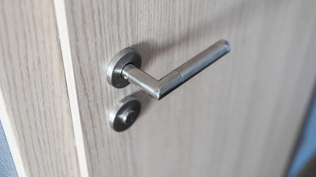 Door handle and inner lock on a wooden doors.の写真素材