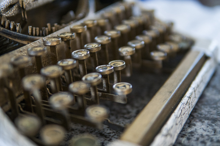 Close up view on an old dirty broken antique typewriter machine keys with Cyrillic symbols letters.の写真素材