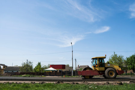 Heavy Vibration roller at asphalt pavement working on the new road construction site. Repairing.