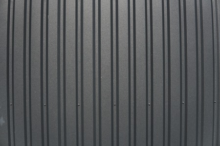 Brown metal plate. Siding. Seamless surface of galvanized steel. Industrial building wall made of corrugated metal sheet, flat background photo texture.の写真素材