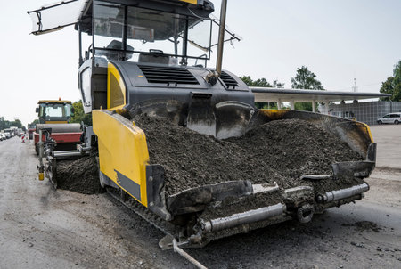 Asphalt paver machine during road construction and repairing works. A paver finisher, asphalt...