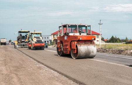 Orange Heavy Vibration roller compactor at asphalt pavement works for road repairing. Working on the...