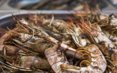 Appetizing grilled royal shrimp. Seafood grill on the stove, on the street food market.の写真素材