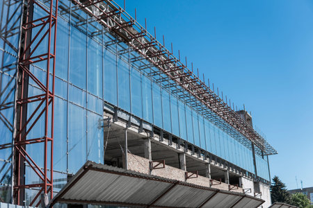 Big inductial building under construction with ablue sky.