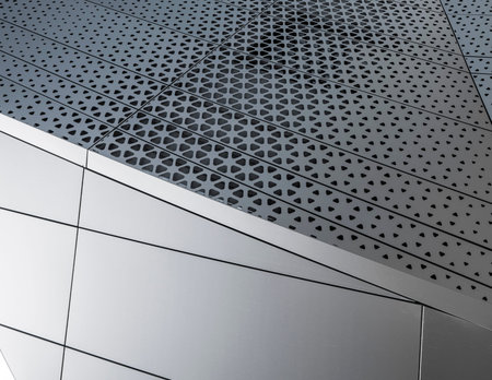 Building with white aluminum facade and aluminum panels.