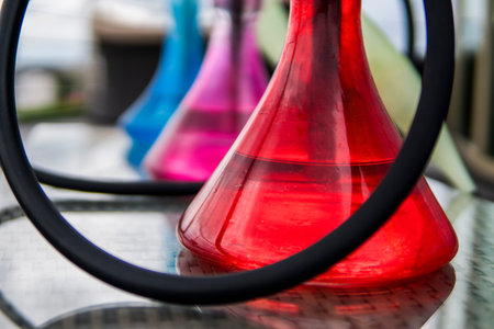 Three colors hookahs on table in hookah lounge in a day.