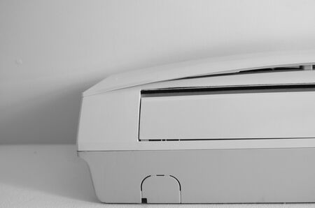 Air conditioner mounted on a white wall in the living room or bedroom. Indooor comfort temperature. Health concepts and energy savings.の写真素材