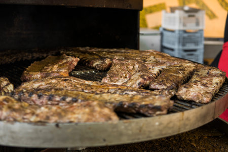 Cooking pork ribs on a grill. Meat on a grills