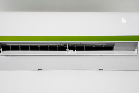 Air conditioner mounted on a white wall in the living room or bedroom. Indooor comfort temperature....