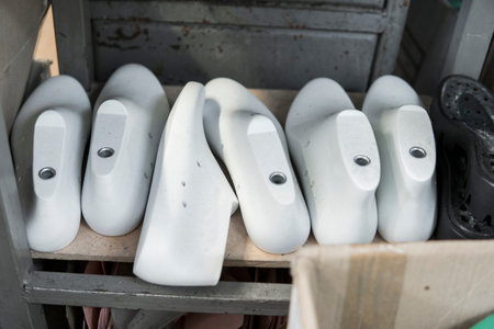 Plastic lasts used in the manufacture of shoes. Row of plastic shoe lasts used to manufacture modern...