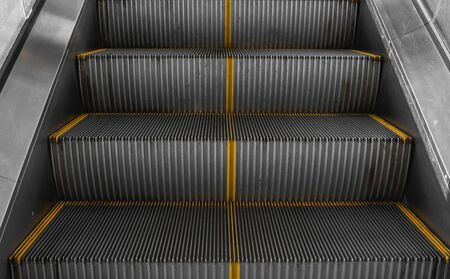 Ditry stairs on Escalator with yellow stripsの写真素材