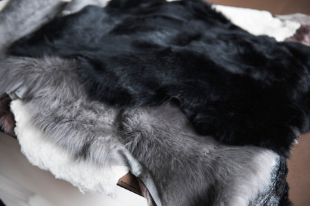 Solid fur pieces of different colors for use in sewing warm and comfortable shoes at a shoe factory.
