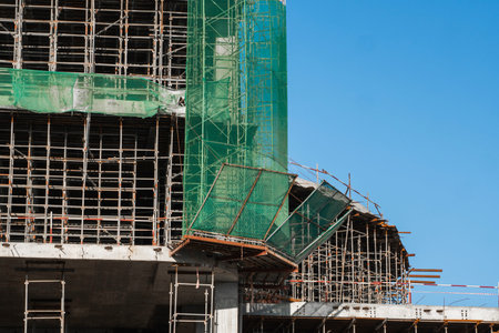Building and Construction Site in progress. Building construction site against blue sky. Metal...