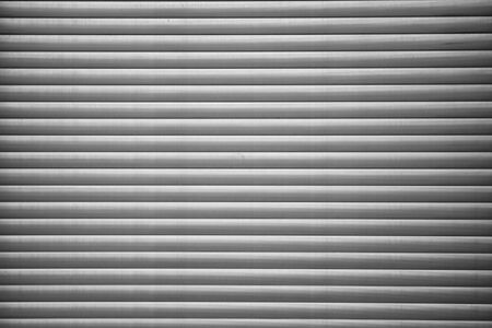 Automatic Factory Shutter Roller Door Indoor, Steel Rolling Gate Door for Security System of Warehouse Storage. Architecture Metal Access Doorway With Granite Wall Background of Workshop Garage.の写真素材