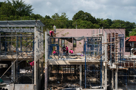 PHUKET, THAILAND - FEBRUARY 10, 2019. Workers work on the new under construction building....