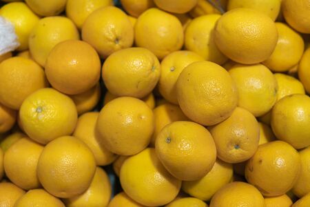 A lot of yellow lemons on a market as a texture or background. Lemon harvest. Healthy and vitamin food. Citrus fruits.の写真素材