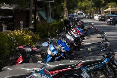KRABI, THAILAND - JULY 10, 2019. Usual crowded parking place in Krabi with full of motorbikes. A lot of motorcycles parking in rows at sidewalk in tourustic place.のeditorial素材