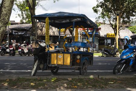 KRABI, THAILAND - JULY 10, 2019. Tuktuk is standing on a road on a street in Krabi. Motorbike taxis are called tuk tuk in Thailand.のeditorial素材