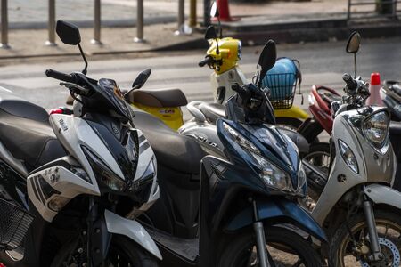 KRABI, THAILAND - JULY 10, 2019. Usual crowded parking place in Krabi with full of motorbikes. A lot of motorcycles parking in rows at sidewalk in tourustic place.のeditorial素材