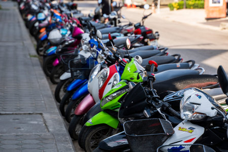 KRABI, THAILAND - JULY 10, 2019. Usual crowded parking place in Krabi with full of motorbikes. A lot of motorcycles parking in rows at sidewalk in tourustic place.のeditorial素材