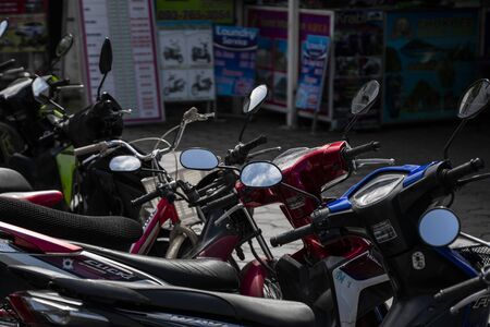KRABI, THAILAND - JULY 10, 2019. Usual crowded parking place in Krabi with full of motorbikes. A lot of motorcycles parking in rows at sidewalk in tourustic place.のeditorial素材