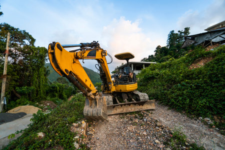 The modern excavator on the construction site with sunset sky. Large tracked excavator standing on a...
