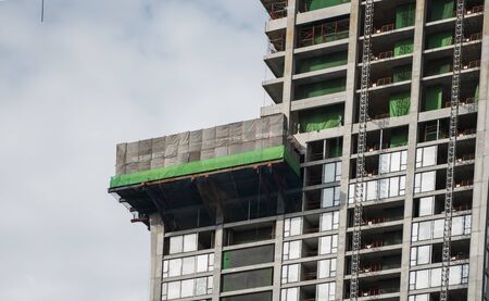 Construction site of building a high-rise building with a cranes against blue sky.の写真素材
