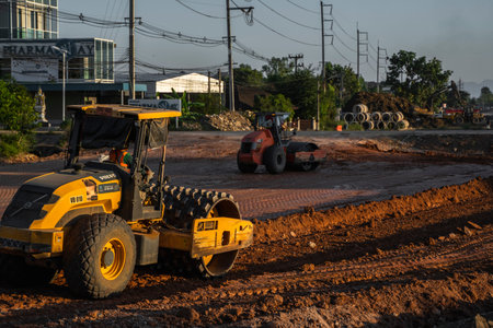 VIETNAM, HO CHI MINH - May 15, 2019: Soil compactor with vibratory padfoot drum. Heavy duty machinery working on highway construction site. Vehicle for soil compaction.のeditorial素材