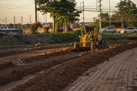 VIETNAM, HO CHI MINH - May 15, 2019: Grader is working on road construction. Grader industrial machine on construction of new roads. Heavy duty machinery working on highway.のeditorial素材
