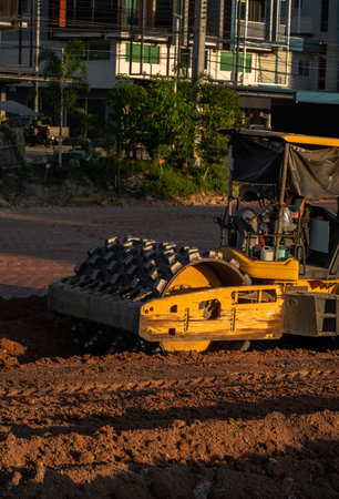 Soil compactor with vibratory padfoot drum. Heavy duty machinery working on highway construction...