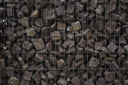 A stone wall that uses metal and stone in harmony. Ecology friendly using a natural resourses for construction. Walls for blocking the collapsing stone.の写真素材