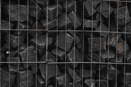 A stone wall that uses metal and stone in harmony. Ecology friendly using a natural resourses for construction. Walls for blocking the collapsing stone.の写真素材