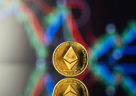 Bitcoins and virtual money concept. Gold ethereum with chart of growing and falling valuance of a...