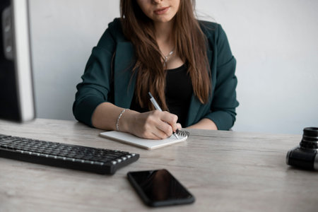 Business woman writing something in notebook. Start-up woman entrepreneur student studying writing...