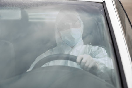 Man in protective suit, medical mask and rubber gloves for protect from bacteria and virus is...