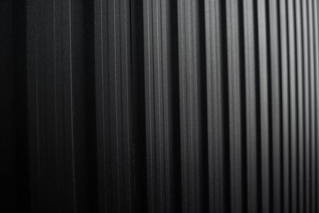 Black Corrugated metal sheet surface of the wall. Galvanize steel backgroundの写真素材