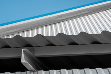 White Corrugated metal sheet surface of the wall and metal corner of the roof. Galvanized steel...
