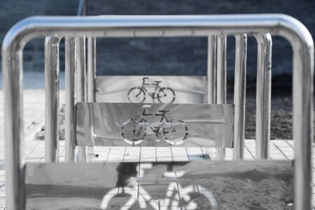 Empty bicycle parking with a sign of bicycle on a streetの写真素材