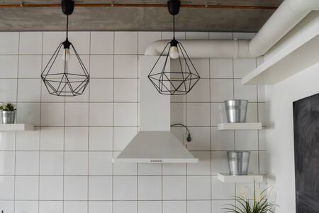 Kitchen hood in Modern, bright, clean, kitchen interior with stainless steel appliances in a luxury house. Kitchen in luxury mansion. Built-in Kitchen appliances ready for comfortable use.の写真素材