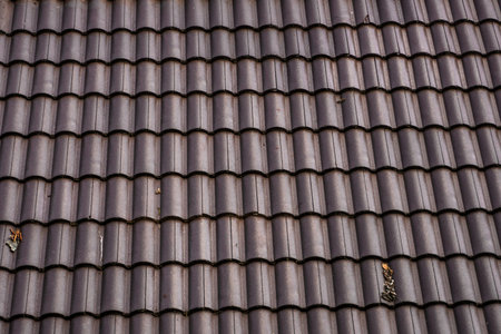Brown natural tile roof. Modern types of roofing materials. Roof of the house, Natural roof tile...