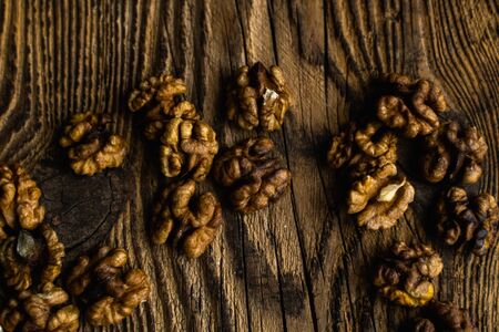 Walnut scattered on the wooden vintage table. Copy space. Walnuts is a healthy vegetarian protein nutritious food. Almonds on rustic old woodの写真素材