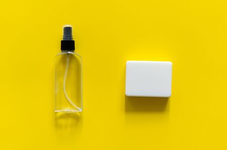 Soap and antiseptic lie on a yellow background. Anti-virus protection kit against covid-19. Coronavirus pandemic 2019の写真素材