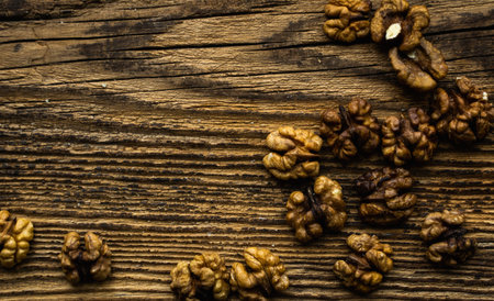 Walnut scattered on the wooden vintage table. Copy space. Walnuts is a healthy vegetarian protein...