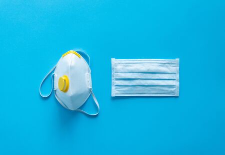 Medical protective mask and respirator ffp lie on a blue background. Anti-virus protection kit against covid-19. Coronavirus pandemic 2019の写真素材