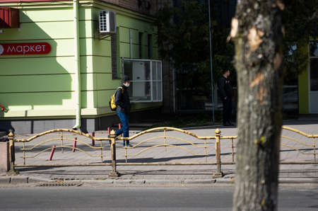 UKRAINE, KYIV - April 25, 2020: Man walks the street wearing a medical mask to prevent of bacterial infection Corona virus or Covid 19 epidemic on street.のeditorial素材