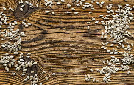 Sunflower seeds scattered on a vintage table. Healthy vegetarian protein nutritious food. Sunflower...
