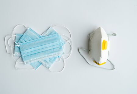 Respirator ffp and medical masks lie on a gray background. Anti-virus protection kit against covid-19. Coronavirus pandemic 2019.の写真素材