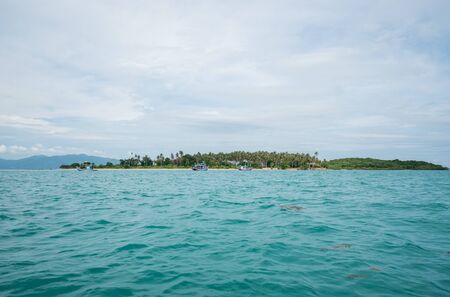 Clear blue sea water with islands, sky and cloud on a horizon. Vacation background in summer in tropical countries.の写真素材