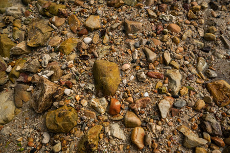 Warm pebble rock beach texture or background.