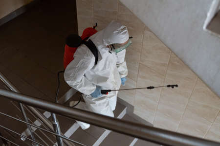 UKRAINE, KYIV - May 20, 2020: Sanitizing interior surfaces. Cleaning and Disinfection inside buildings, the coronavirus epidemic. Professional teams for disinfection efforts. Infection prevention and control of epidemic.のeditorial素材